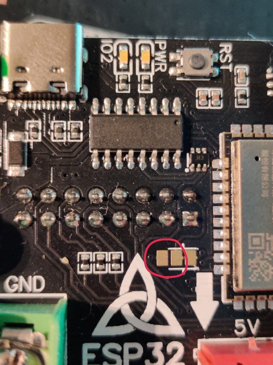 Picture showing the left two of the three solder pads circled